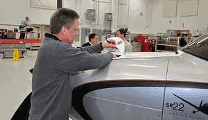 Cirrus co-founder Dale Klapmeier adds his signature to one of the Limited Commemorative Edition SR22Ts. (Cirrus)